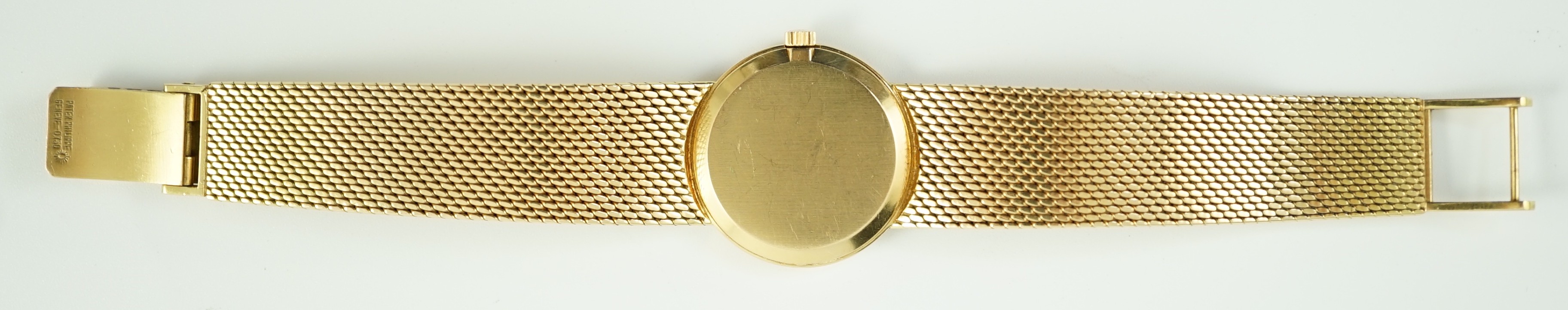 A lady's 18ct gold Patek Philippe manual wind wrist watch, on an integral 18ct gold Patek Philippe bracelet